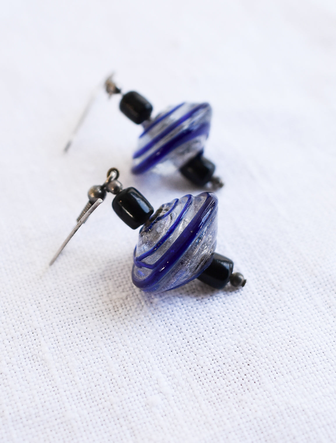 Blue and black glass swirly bead earrings